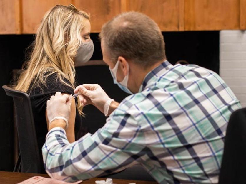 A person gets a flu shot in their arm